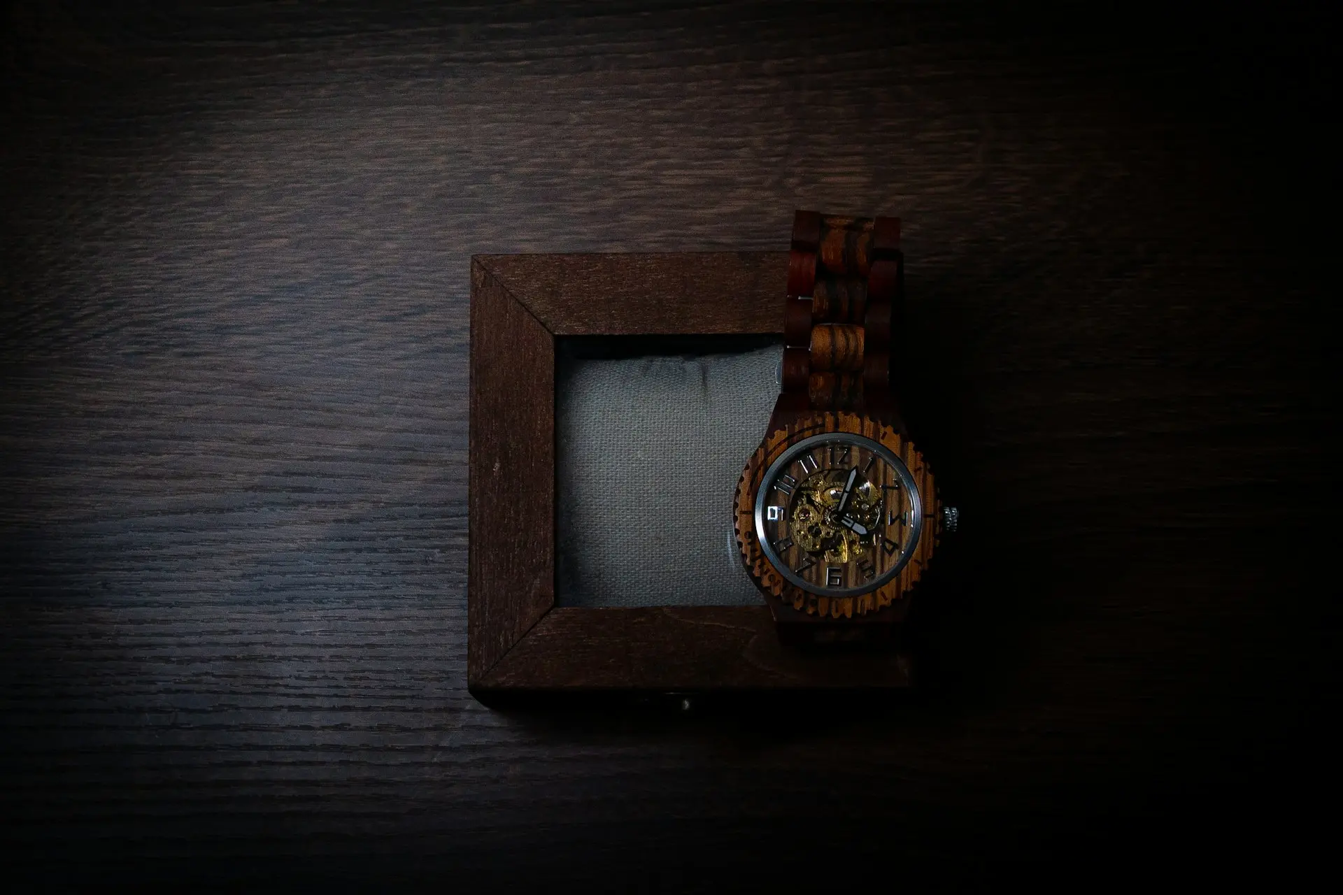 a watch in a wooden box on a table